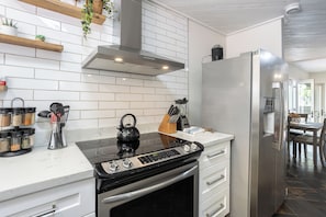 Full kitchen with stainless steel appliances, popcorn machine & pancake maker.