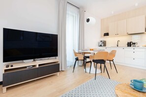 A large open lounge space with modern furniture, plants, and lounge chairs, offering a perfect relaxation spot.