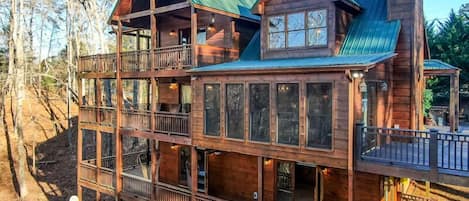 The property is "All Decked Out" with triple decker wrap around decks,