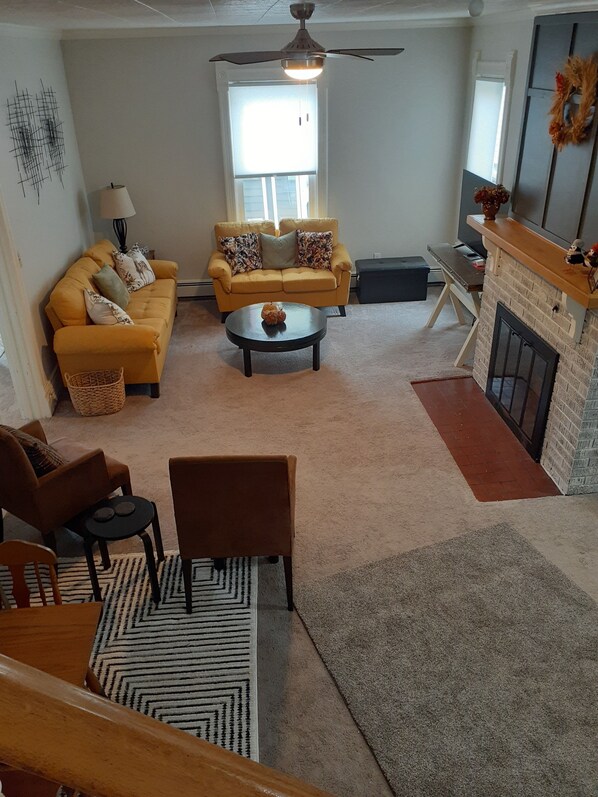 Living Room and Game area table/cabinet in foreground.