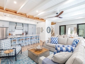 Open plan dining and living areas looking out to pool and patio