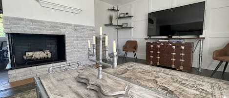 Comfortable living room space with huge smart TV!