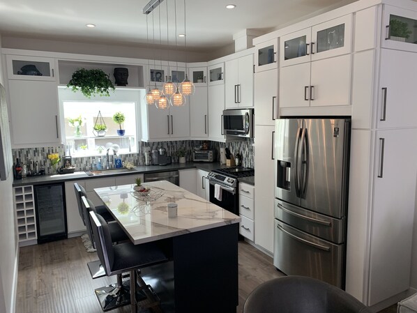 Beautiful Kitchen with new stainless appliances and wine cooler and LED lights
