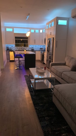 Night view with LED lights looking from living room into kitchen 