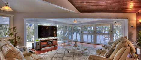 Living Area with floor-to-ceiling windows, big screen smart TV, 6 recliners