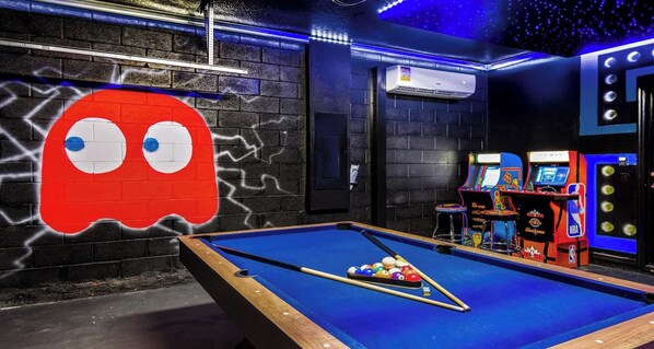 Retro arcade dream with pool table, neon lights, and classic game vibes!
