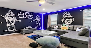 Star Wars lounge with galactic murals, plush seating, and out-of-this-world vibes!