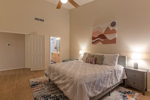 Enjoy sweet dreams in the cozy primary suite with a king bed, ceiling fan and en suite bath.
