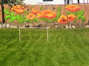 Welcome to your vacation home.  Soccer net for the kids and our mural of flowers