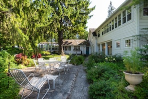 Side view of house - stone patio with gas grill for relaxing & dining