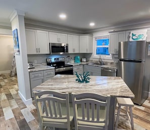 New Beautiful kitchen with Stainless Steel appliances and granite countertops.