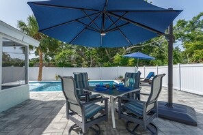 Outdoor dining table and cantilever umbrella with LED lights.  Enjoy meals next to the pool in the sunshine or shade.