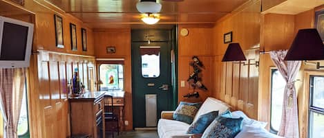 Grape Escape caboose has 1 queen bed and 1 full size sofa bed