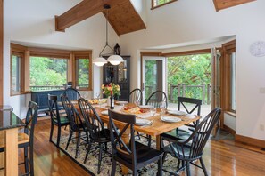 Large dining table that seats ten and opens to the outdoors.