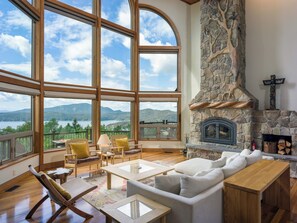 Vaulted ceilings, Scandanavian furnishings, and stone fireplace look out to views in every diretion.