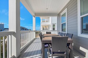 Spacious covered balcony with Gulf Views, grill, and outdoor dining table