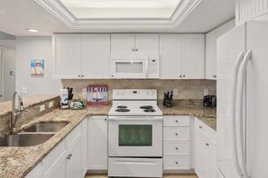 Fully equipped kitchen perfect for preparing gourmet meals in the comfort of your very own condo