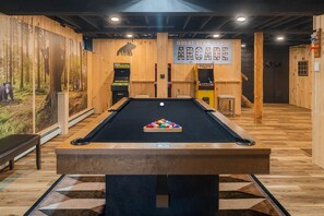 Rain or shine, the fun never stops in our game room—featuring a sleek pool table, classic arcade machines, and plenty of space to unwind and play