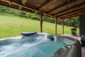 Soak in the serenity from your private hot tub on the covered back porch—surrounded by trees, birdsong, and the occasional deer wandering by at dusk.