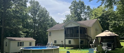 View of the backyard where the pool/ hottub grill/ outdoor dining set & firepit.