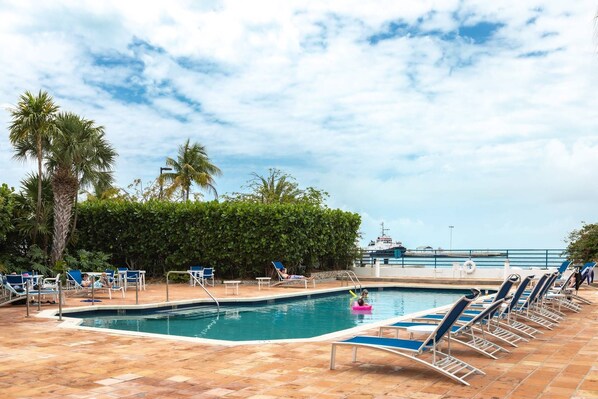 Indulge in a refreshing escape as you cool off in the pool while soaking in picturesque views of the Key West harbor.