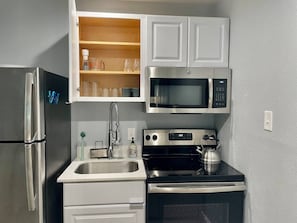 Fully stocked kitchen - equipped with Keurig, coffee pods, French Press, microwave, toaster oven, blender, Brita water pitcher and full set of cookware and dinnerware. 