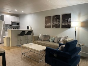 Comfortable living room with counter height bar stools to eat or work.