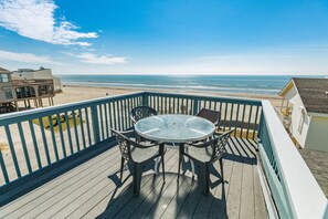 Dine al fresco and watch the dolphins swim in the surf