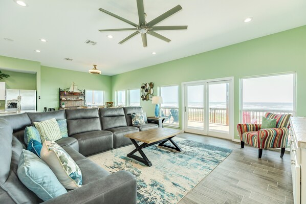 Living room with wall of windows showcasing the beachfront views