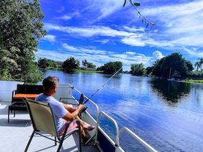 Fishing right on the backyard pontoon boat dock