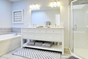 Upstairs bathroom with a shower and tub.  