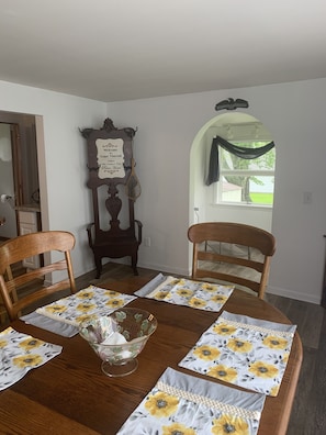 Dining room with 4 chairs, a bench and a great window with a beautiful view.