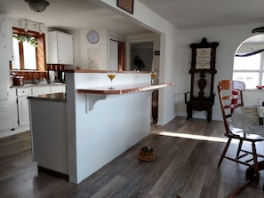 Kitchen island, opposite of the Copper bar is where the stove is located.