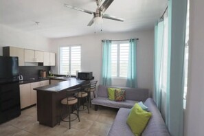 View from front door  Entry.  Open Space, Living/Kitchen Area.  Wall  Mounted TV