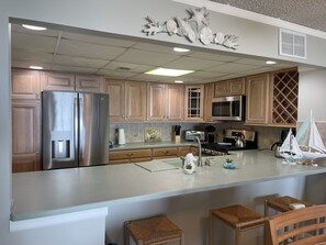 Bright and open kitchen with breakfast bar.