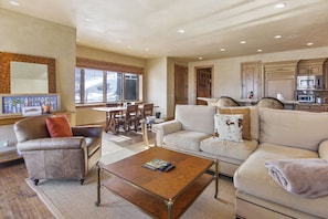 Living room with Kitchen and dining room in background