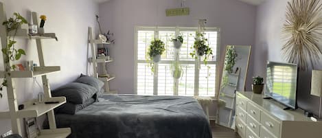 Spacious bedroom with lots of light and plants.  Wooden shutter blinds.  Comfy…