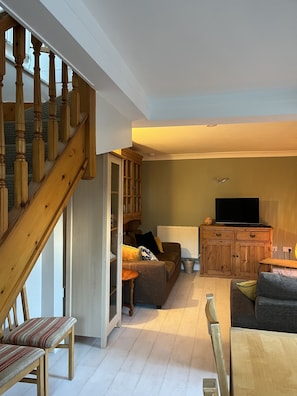 Lower floor open plan sitting room / dining room 
With television .