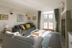 Large living room with patio doors onto private garden