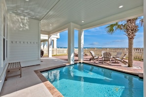 Heated, private pool with gulf views, outdoor seating, lounge chairs, and grill.