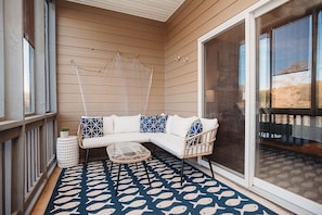 Screened in outdoor patio off the master with a direct view of the lake.