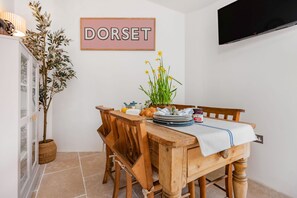 Little Dorset Cottage, Blandford: The dining area with television