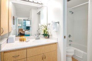 Full bathroom with tub and shower combo.