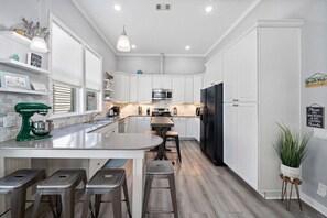 Follow the flow of the home and step into the fully stocked kitchen, many seats for dining, and beautiful decor throughout!