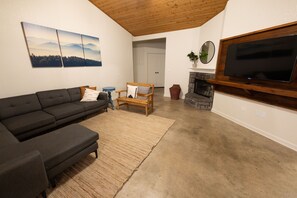 Main living area with polished concrete floors and 55" smart tv 