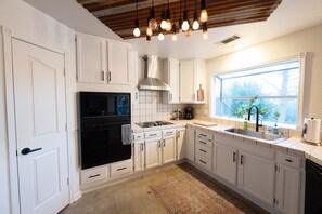 Open kitchen with windows looking out over backyard