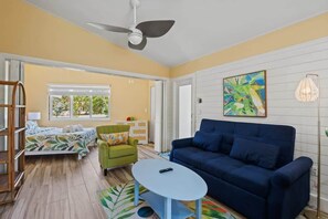 Comfy master bedroom with Queen bed closes off from the living area through accordion doors for extra privacy