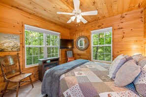 Primary bedroom with Queen 12" memory foam mattress, elec. fireplace and Roku tv