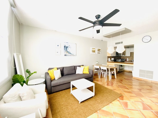 living room, large ceiling fan,  sofa bed, and dining table.