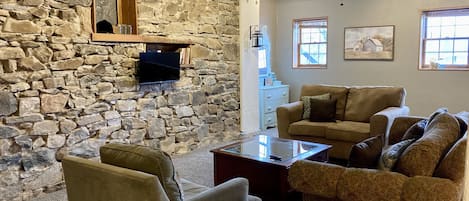 Main living area features a large comfy seating group and TV.